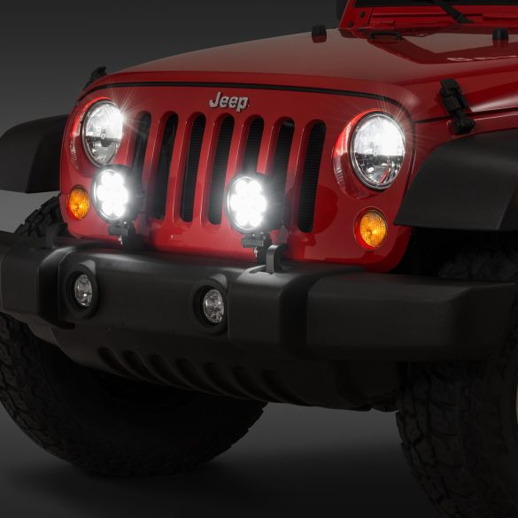 Bright LED headlights on a red Jeep Wrangler